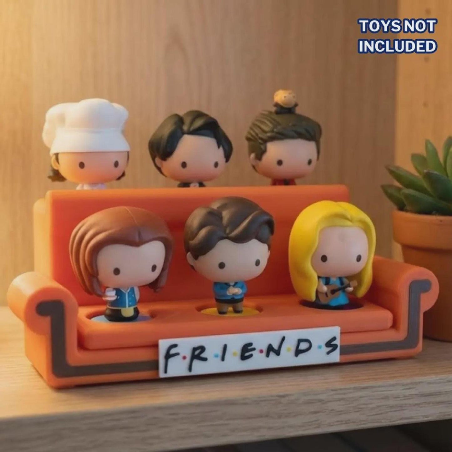 Orange sofa display stand; FRIENDS base, 90s nostalgia desk decor for toy collectors.